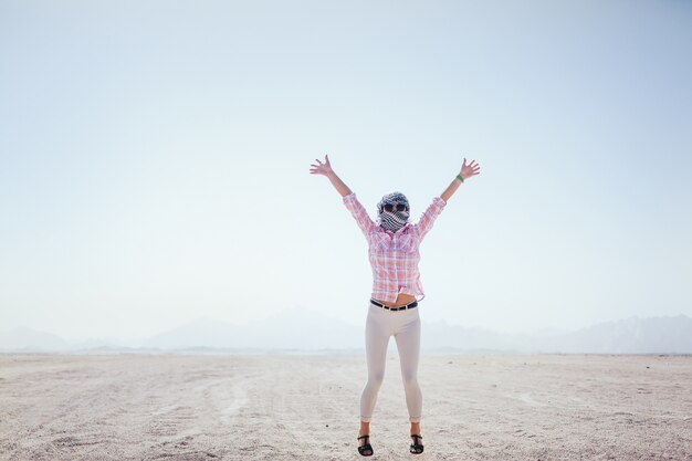 Girl jumps on the sand in egypt