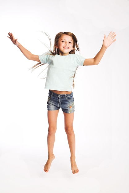 Girl jumps on a white background