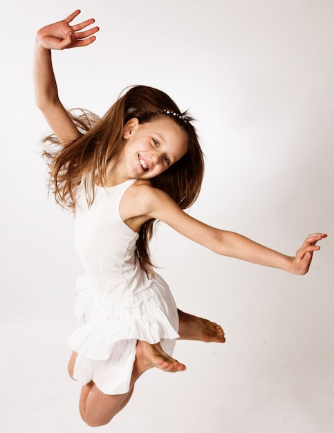 Girl jumps on a white background