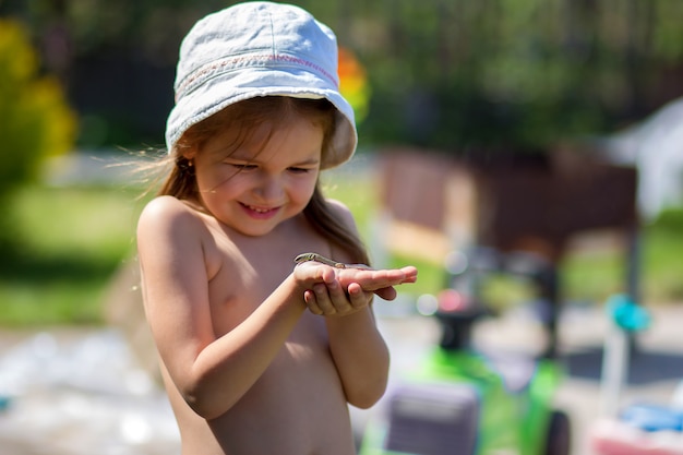 The girl keeps in a hat on a hand