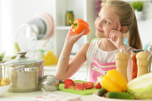 Girl on the kitchen cook to eat