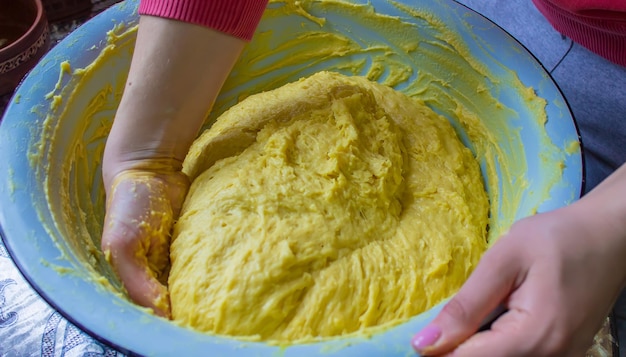 The girl kneads the dough in a bowl selective focus