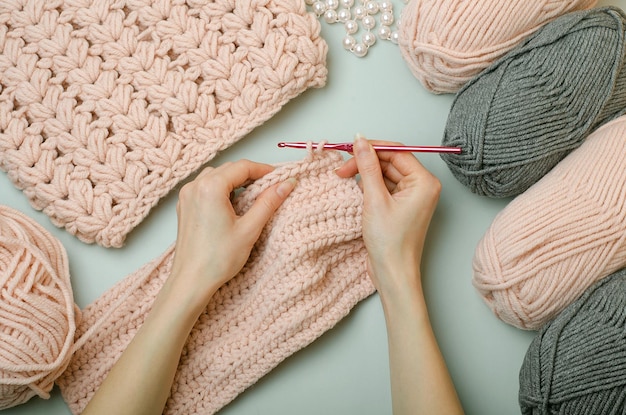 The girl knits a sweater crochet