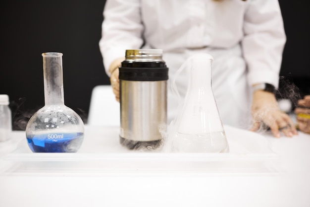 A girl laboratory assistant conducts a laboratory experiment