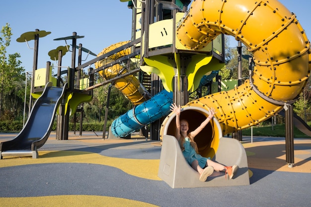 Girl at the large beautiful playground in the park