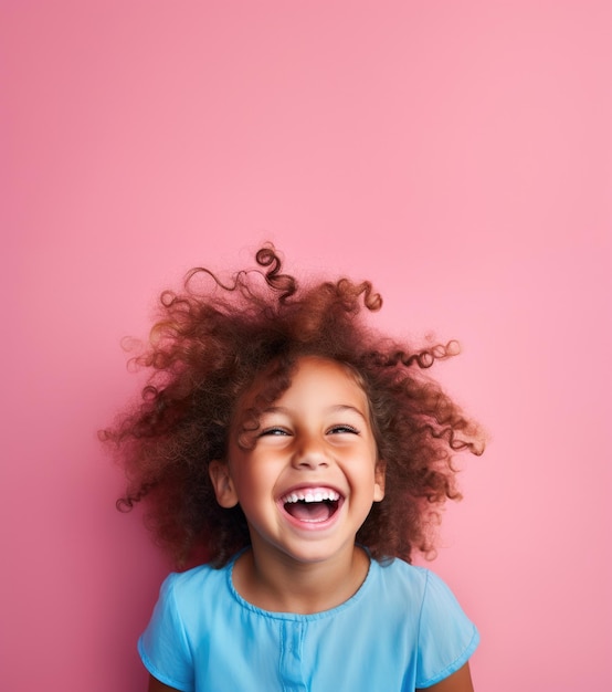 Girl laughing out loud on pink isolated background