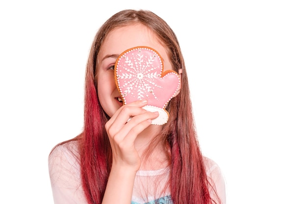 The girl laughs with a Christmas gingerbread glove in her hands Teenage girl isolated on white