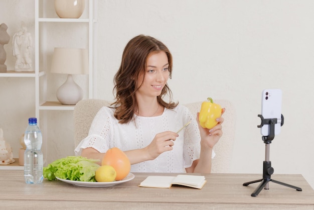 The girl leads an online conference on healthy eating the concept of vegetarianism