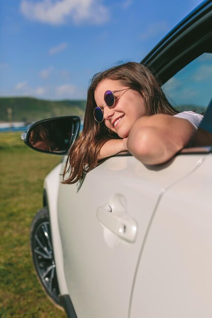 Girl leaning on window of the car