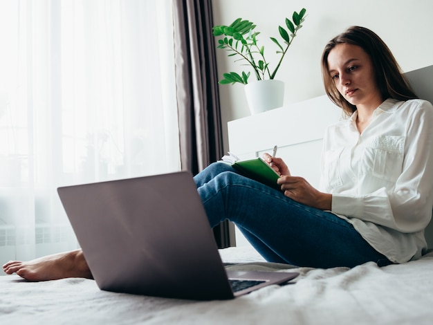 Girl learns, works, self-develops online while sitting at home