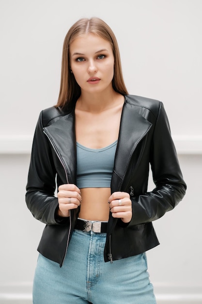 Girl in a leather jacket and blue jeans