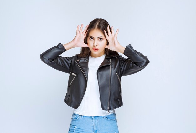 Girl in leather jacket looks scared and terrified. 