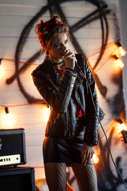 Girl in a leather jacket with a microphone