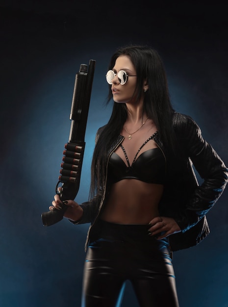 The girl in a leather jacket with a shotgun