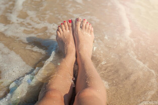 Girl legs in sea