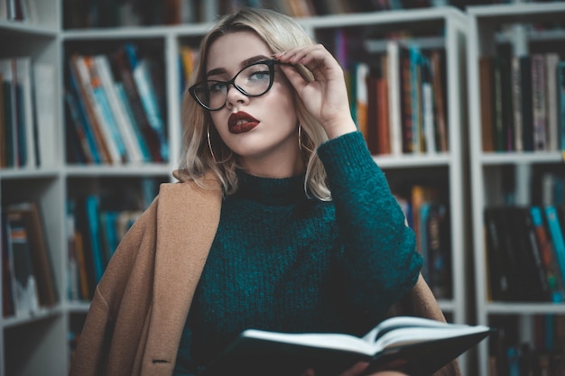 Girl in the library reading a book