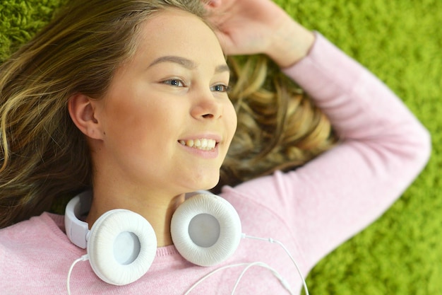 Girl lies on the floor and listens to music