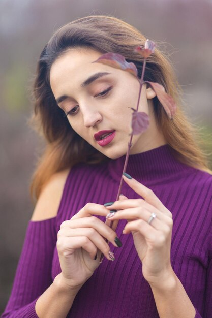 Girl in lilac dress on nature in autumn Portrait of a beautiful girl in the autumn in the forest