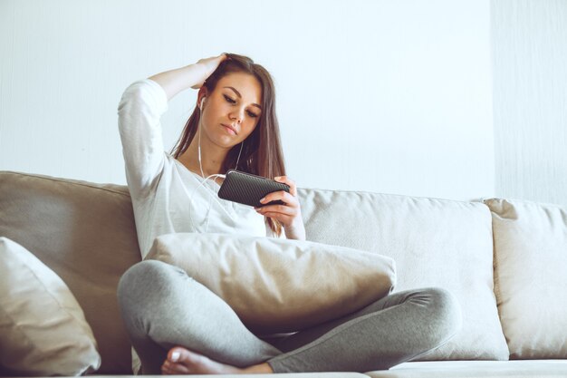 Girl listening to music while sitting on the couch