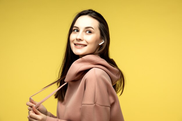 girl listening to music in wireless earphones and smiling