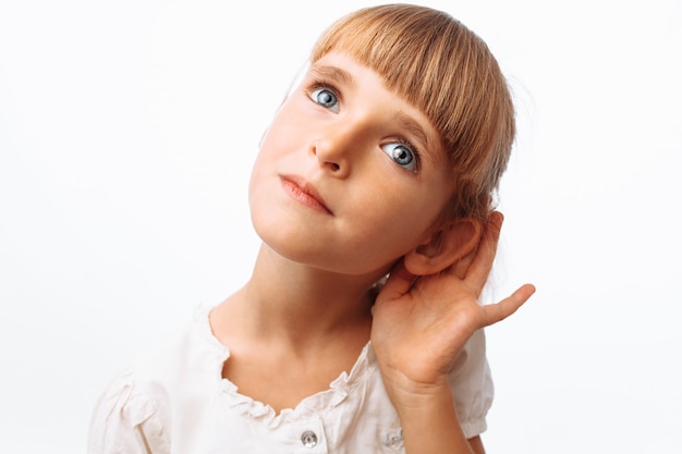 Girl listening on white wall