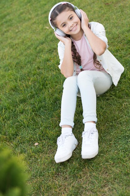 girl little tourist kid using audio guide mobile application audio tour headphones gadget free style of travelling exciting journeys through cities and museums city guide and audio tour
