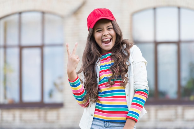 Photo girl living happy life positive concept smiling girl cheerful schoolgirl happy smiling child have fun emotional happy kid outdoors happy expression celebrate childrens day summer vacation