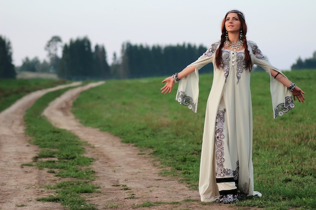 Girl in long dress road country