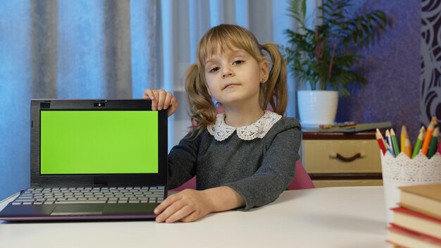 Girl looking away while sitting on table