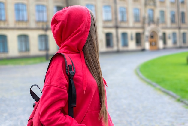 Girl looking back at campus building