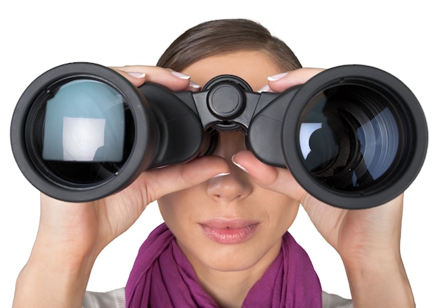 Photo girl looking into binoculars on light background