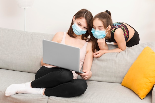 Girl looking on mom laptop