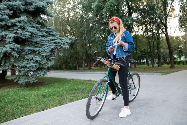 Girl looks at the bike route on the smartphone