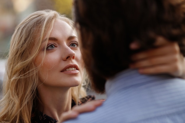 girl looks at a guy in love. a couple. close-up portrait. blurred background