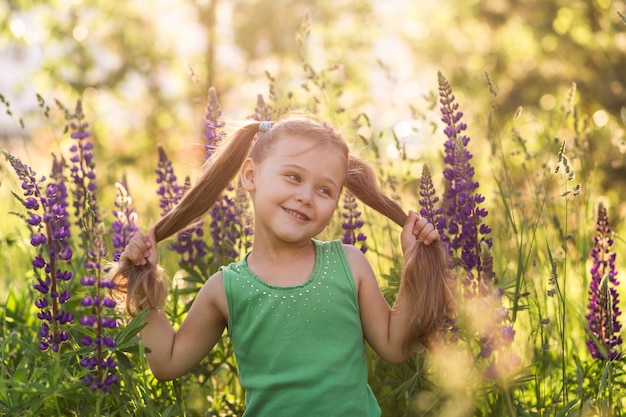 girl and  lupine flower in nature