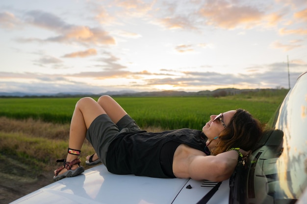 Girl lying on a car hood