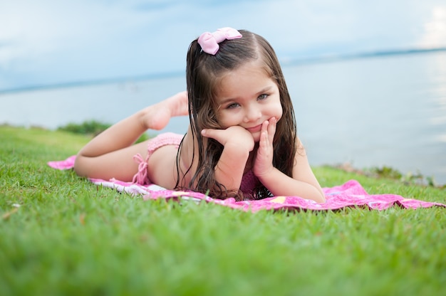 Girl lying on the grass with happiness face