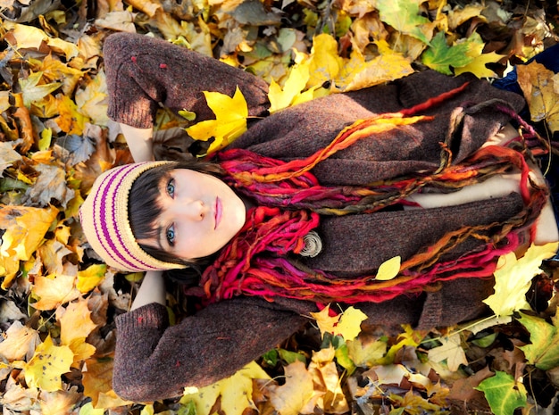 Girl lying in leaves.