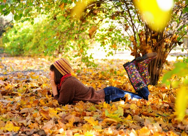 Girl lying in leaves.