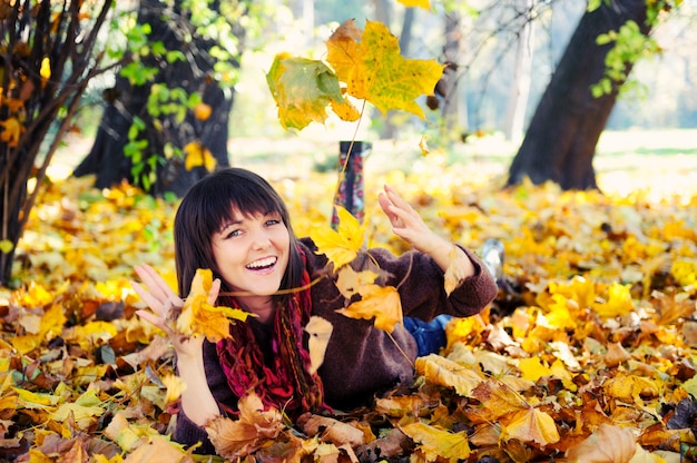 Girl lying in leaves.