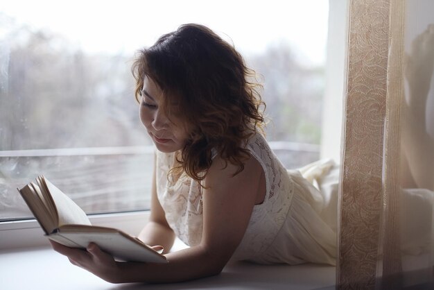 girl lying and reading