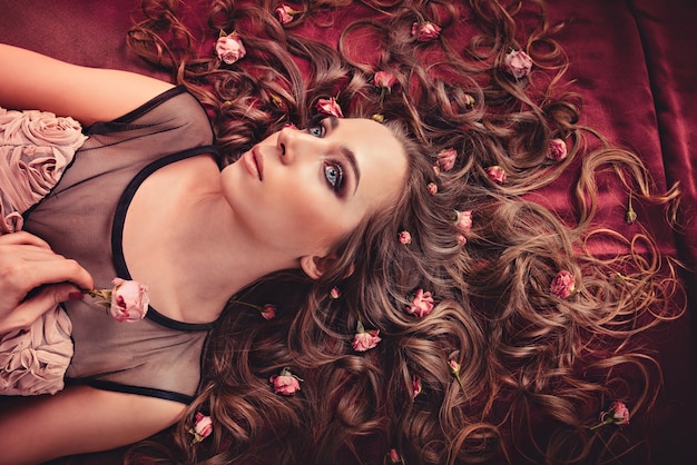 Girl lying with flowers on hair