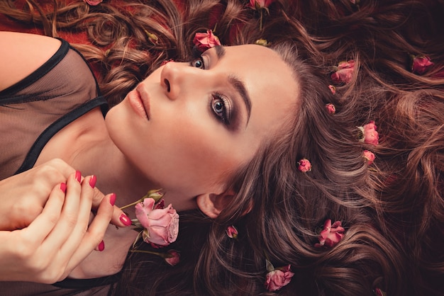 Girl lying with flowers on hair