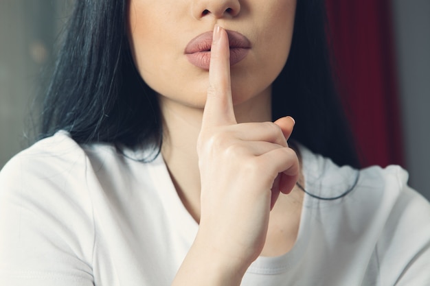 Girl makes a gesture of silence