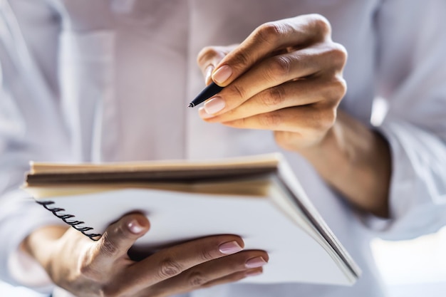 Girl makes notes in a diary Closeup