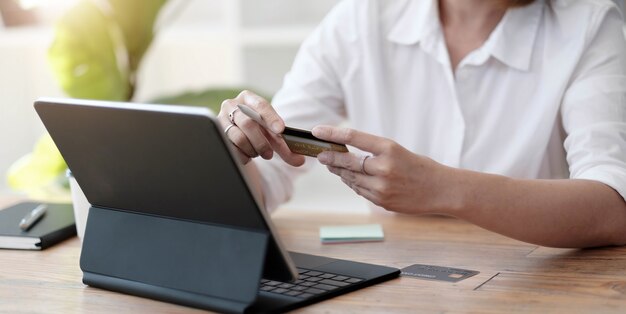 Photo girl makes a purchase on the internet on the computer with credit card