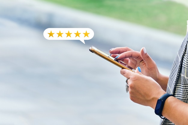 Photo girl makes a review with a rating using a smartphone.