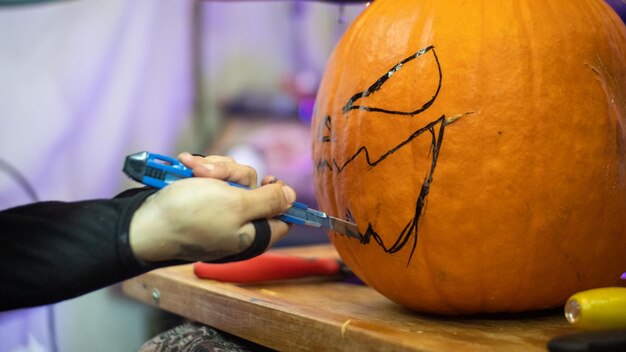 Girl making a halloween pumpkin