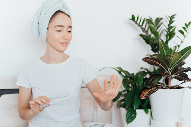 Photo girl making a manicure herself and using a nail file at home because of the coronavirus epidemic