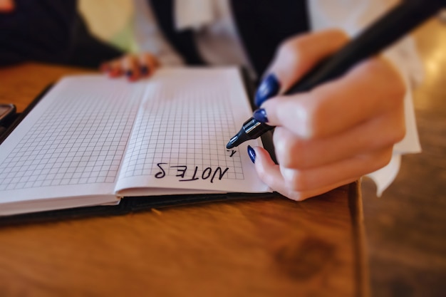 Girl making notes on paper, clean space